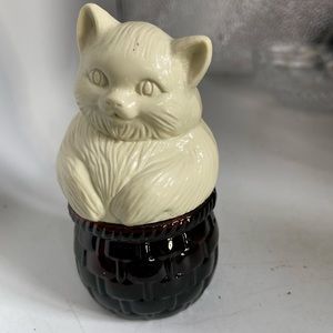 Avon white kitty on a brown glass basket 3.5” tall 2” at widest